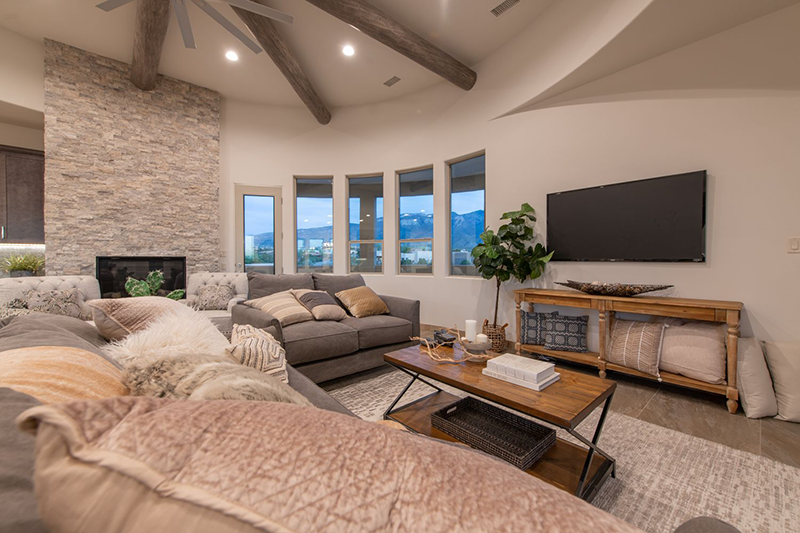 High Desert Living Vistas - Floor to ceiling stone face fireplace sets the mood and anchors the living area