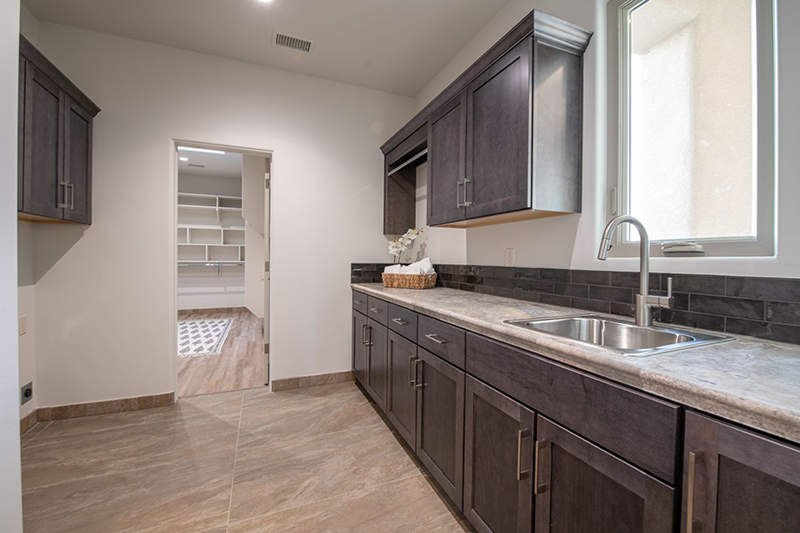 Laundry is located just off the master bedroom and completes the flow into the kitchen