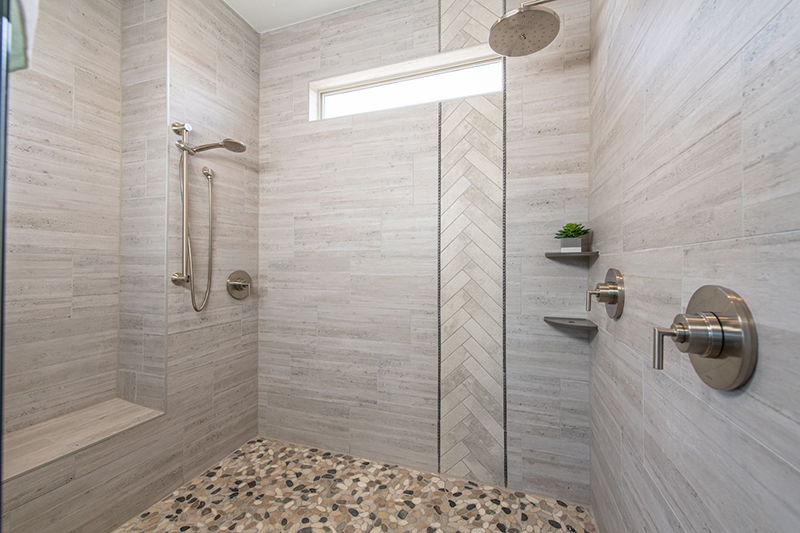 Just off the Two Person Rain Shower with Bench river rock and artistic stone inlays